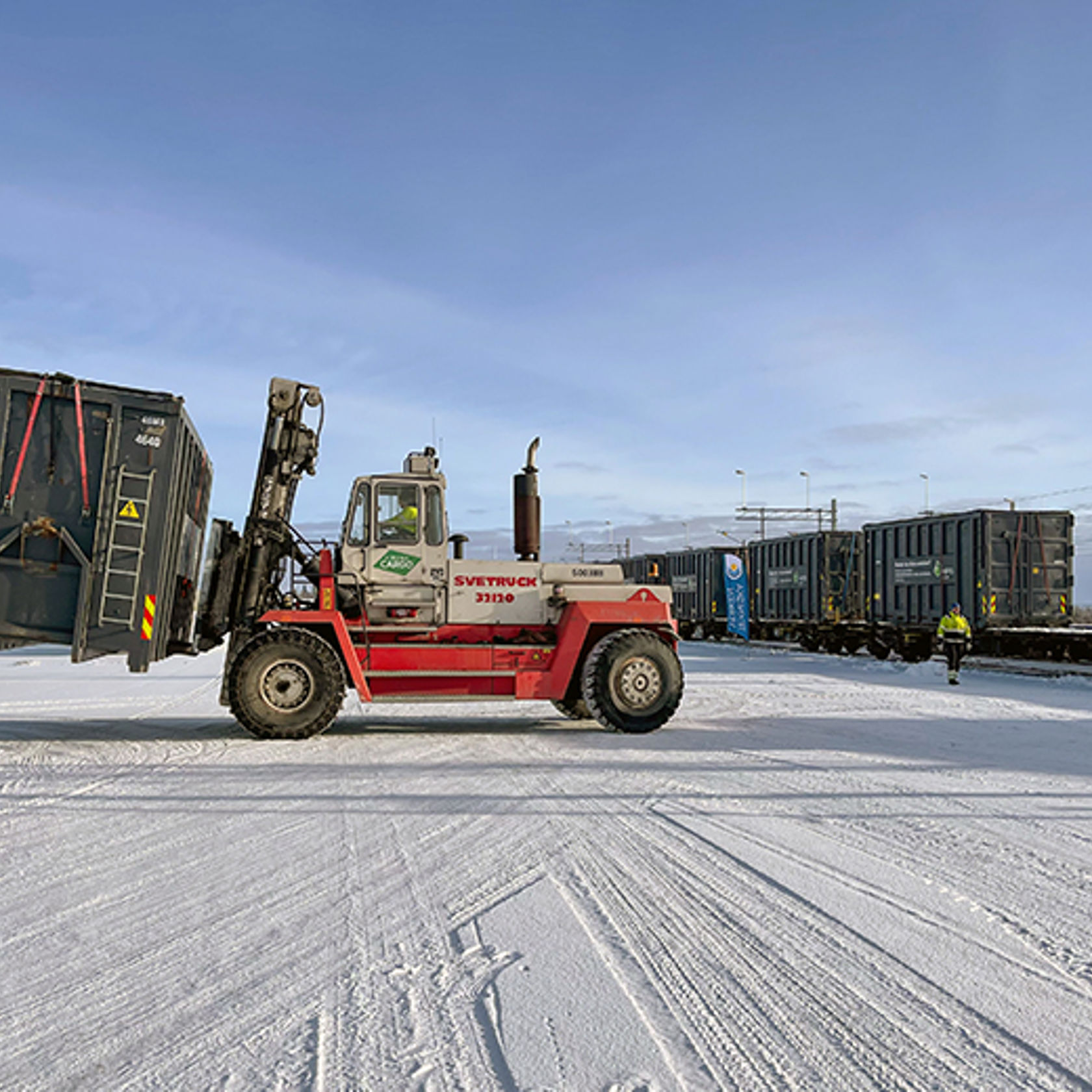 Stor truck på godsterminal i vinterlandskap